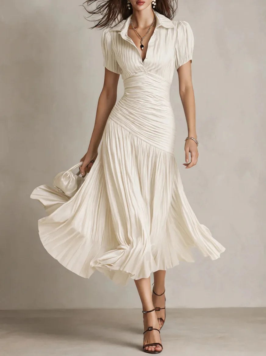 White pleated midi dress for women by Tammy Bradley, featuring a flowy, elegant design with a fitted waist and classic pleats.