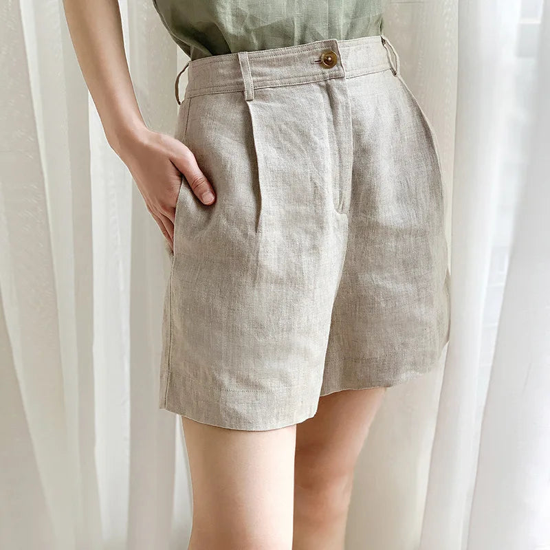 High-waist pleated linen shorts for women featuring tailored design, perfect for office or casual wear, in a light linen fabric.