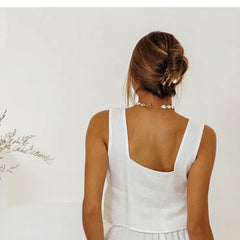 Linen wide-leg women's trousers with a loose, pull-on fit, shown in a relaxed style with natural fabric texture.