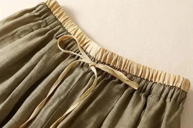 Beige tapered linen trousers for women, loose pull-on pants with a relaxed fit, stylish and comfortable for casual wear.