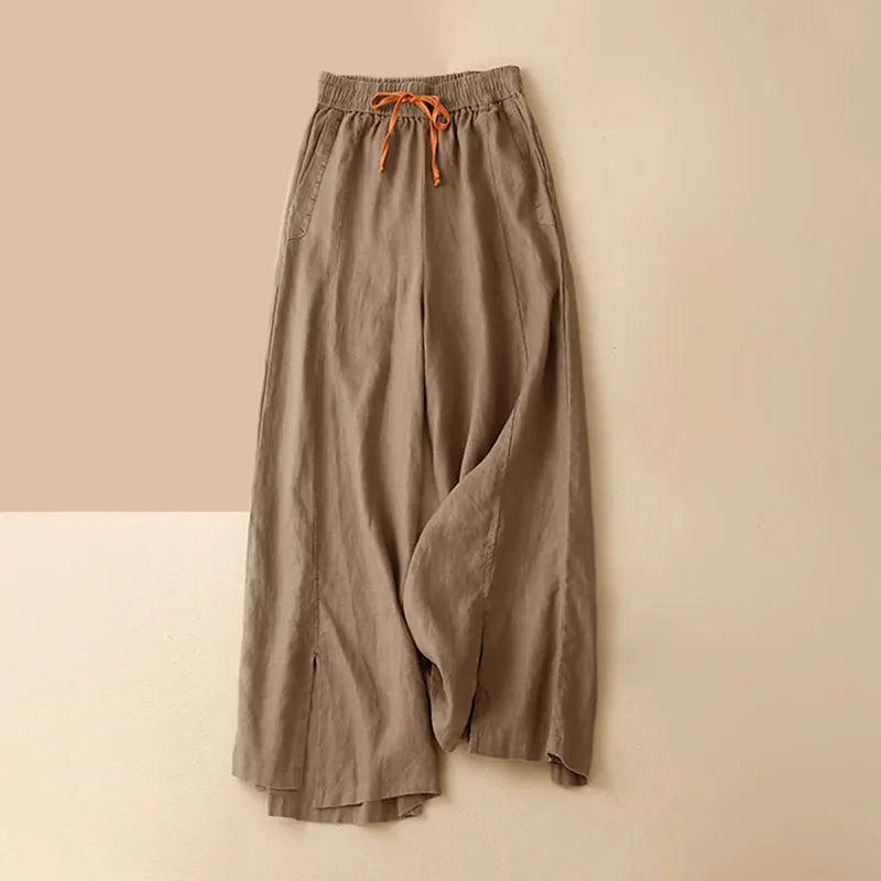 Women's linen wide-leg drawstring trousers with a loose fit, featuring a comfortable pull-on design and relaxed style.