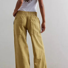 Blue denim wide-leg women's jeans with relaxed fit, casual pants style, shown on a model.