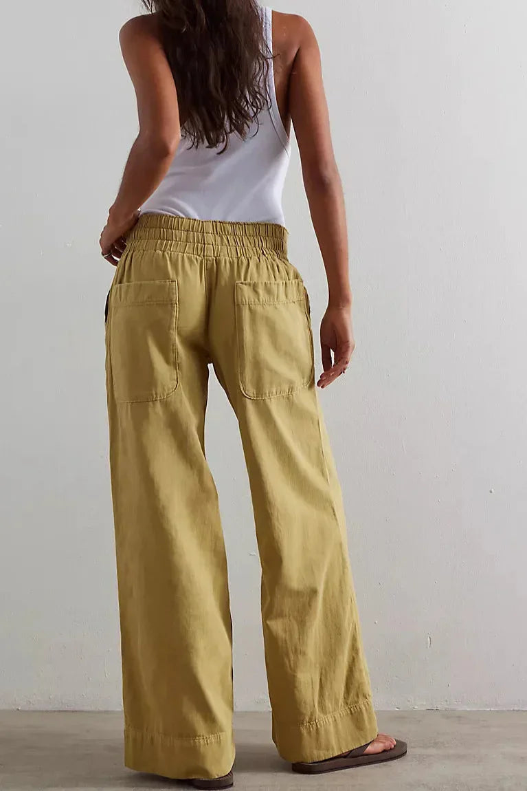 Blue denim wide-leg women's jeans with relaxed fit, casual pants style, shown on a model.