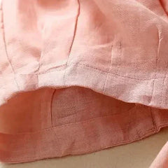 Beige tapered linen trousers for women, loose pull-on style, featuring a relaxed fit and lightweight fabric.