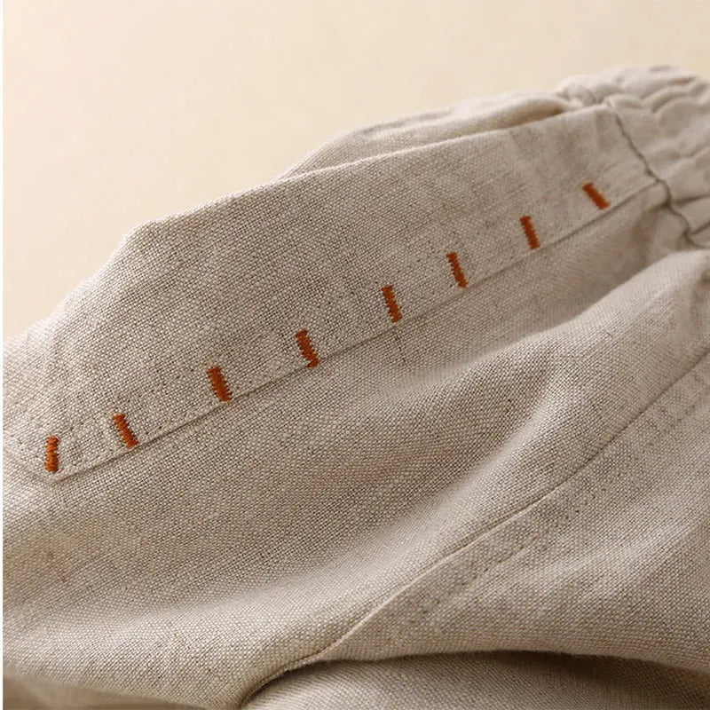 Women's linen wide-leg drawstring trousers with a loose fit, featuring a comfortable pull-on design and relaxed style.