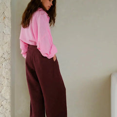 Women's high-waist wide-leg linen blend trousers with a loose pull-on design, displayed on a model in a casual setting.