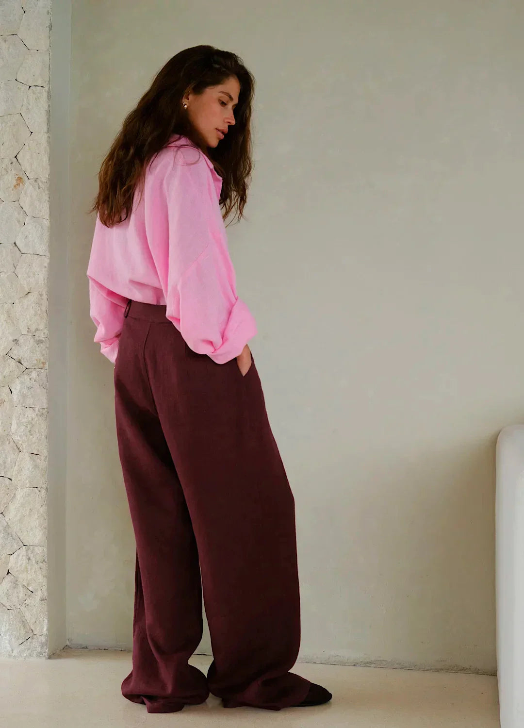 Women's high-waist wide-leg linen blend trousers with a loose pull-on design, displayed on a model in a casual setting.