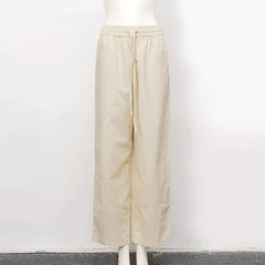 Light beige cotton linen wide-leg drawstring trousers for women, loose pull-on pants with a relaxed fit and comfortable waistband.