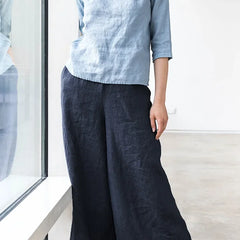 Linen cropped wide-leg drawstring trousers for women, loose pull-on style with relaxed fit, in neutral linen fabric.