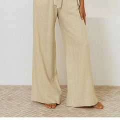 Linen wide-leg pull-on trousers for women, loose fit, natural beige color, styled casually with a relaxed fit and high waist.