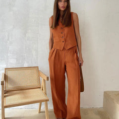 White women's high-waist wide-leg linen trousers with relaxed fit, showcasing their flowy, breathable fabric and stylish silhouette.