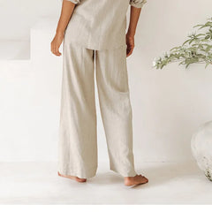 Women’s linen wide-leg trousers with a loose pull-on design, featuring a relaxed fit and natural fabric texture.