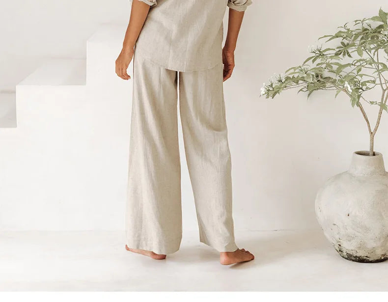 Women’s linen wide-leg trousers with a loose pull-on design, featuring a relaxed fit and natural fabric texture.