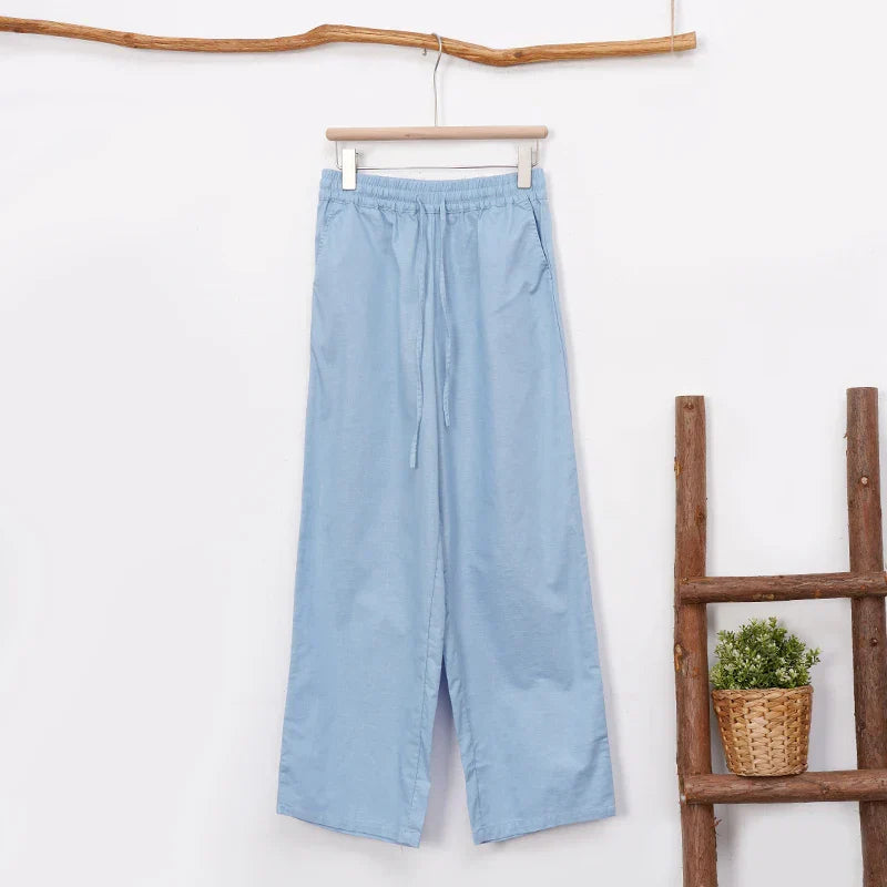 Women's cotton linen wide-leg drawstring trousers with a loose fit and pull-on style, shown in natural fabric and relaxed design.