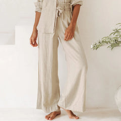 Light beige linen wide-leg trousers for women with a loose pull-on style, featuring a relaxed fit and natural fabric texture.