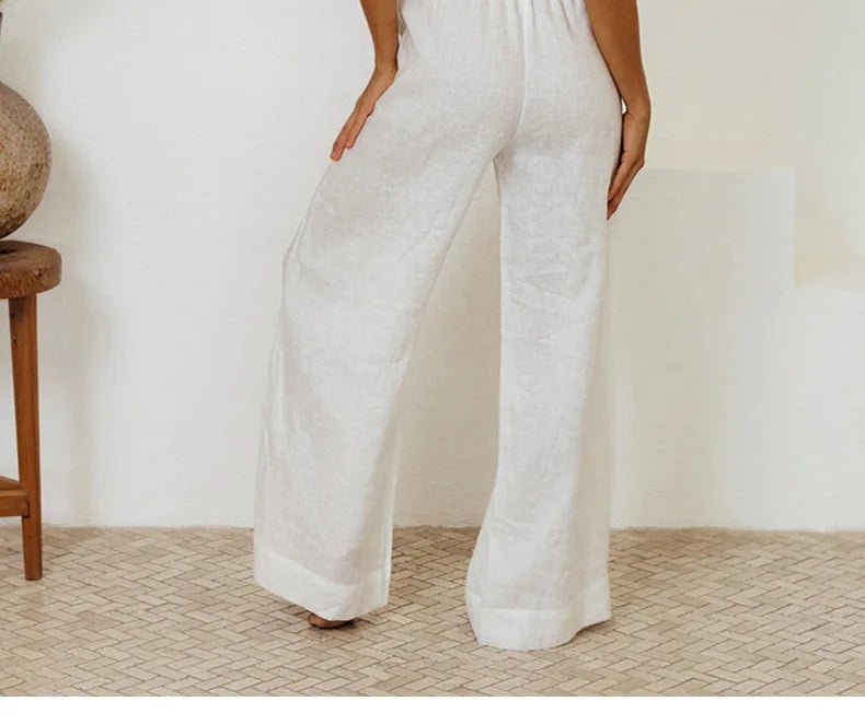 Light beige linen wide-leg women's pants with a loose, pull-on design, styled with a relaxed fit.