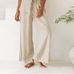 Light beige linen wide-leg women's trousers with a loose pull-on style, featuring a relaxed and comfortable fit.
