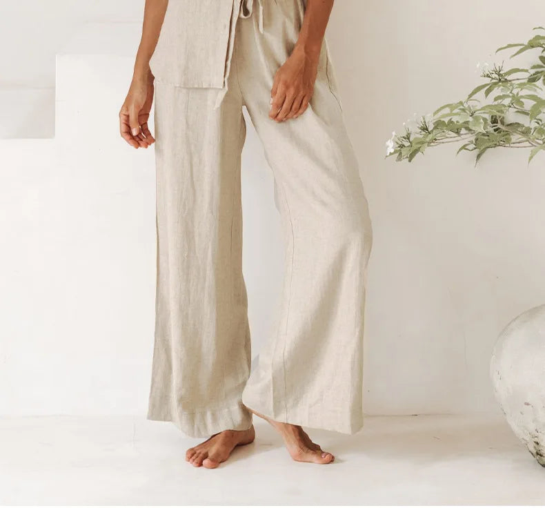 Light beige linen wide-leg women's trousers with a loose pull-on style, featuring a relaxed and comfortable fit.