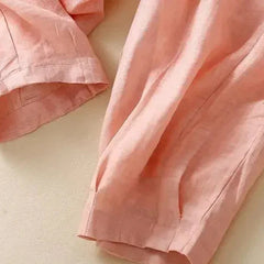 Light beige tapered linen trousers for women featuring a loose pull-on style, stylish and comfortable for casual wear.