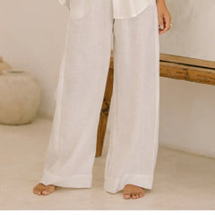 Light beige linen wide-leg women's trousers with a loose fit and pull-on design, displayed on a model.