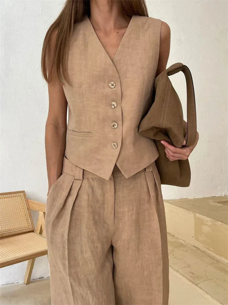 Women's white high-waist wide leg linen trousers, stylish and comfortable pants for women, shown in natural fabric detail.