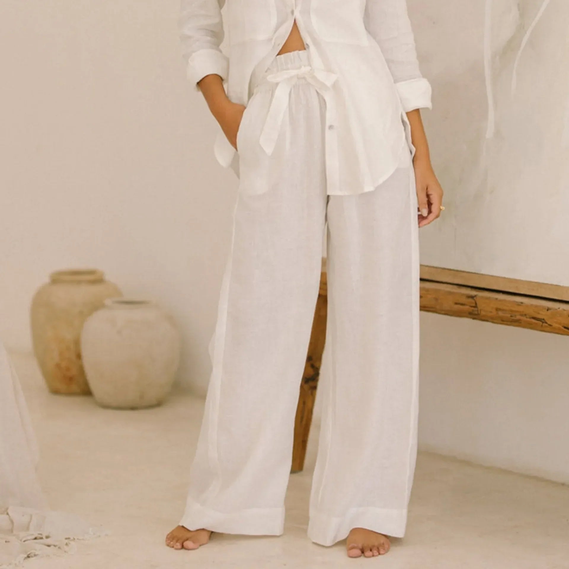 Linen wide-leg pull-on trousers for women, loose fit, natural fabric, showing the relaxed style and light texture.