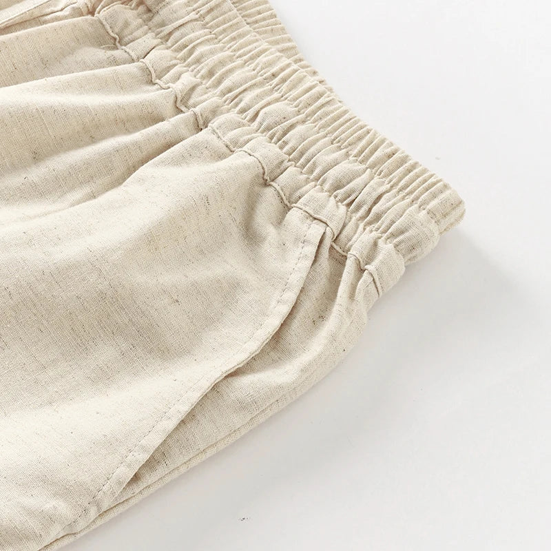 Light beige cotton linen wide-leg drawstring trousers for women, loose pull-on style with relaxed fit and comfortable waistband.