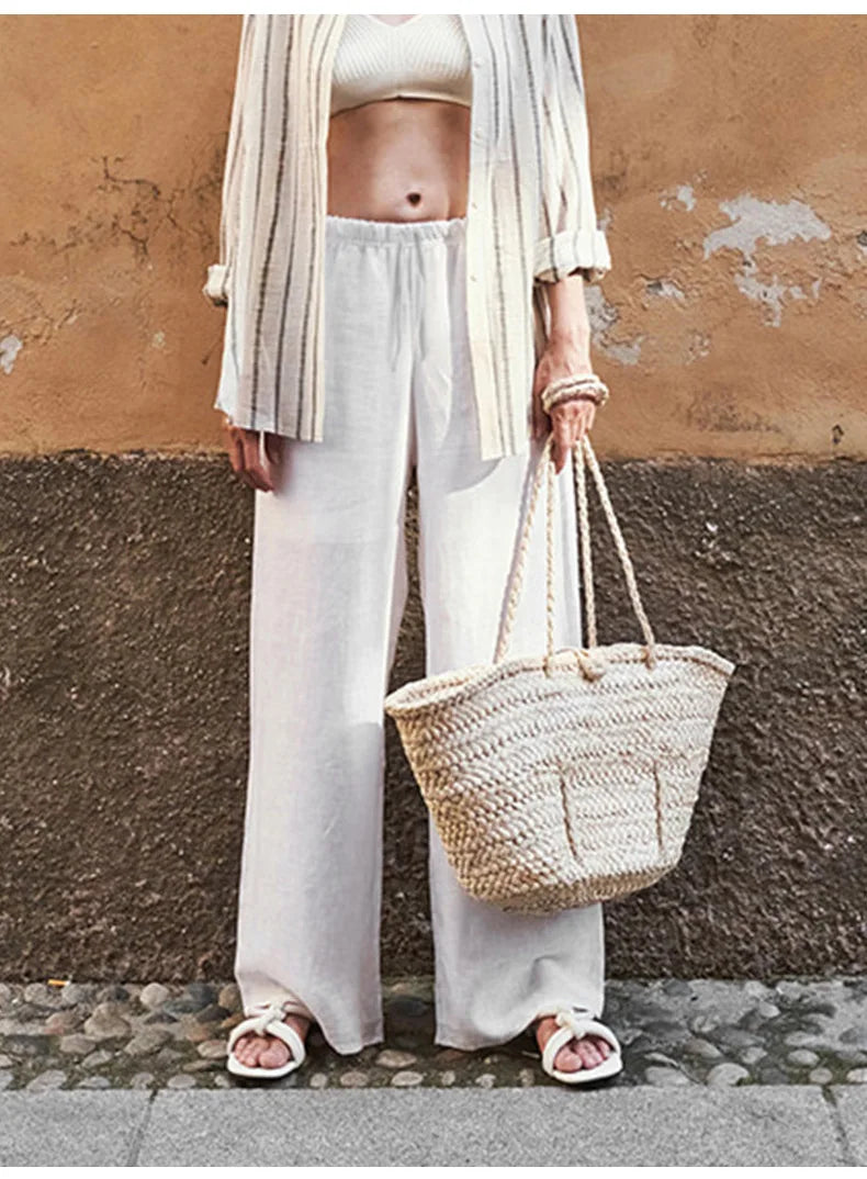 Knit wide-leg drawstring trousers for women featuring a loose fit, pull-on style, and casual comfort.