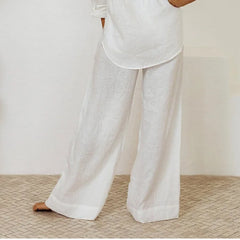 Light beige linen wide-leg trousers for women featuring a loose pull-on design, casual and comfortable for everyday wear.