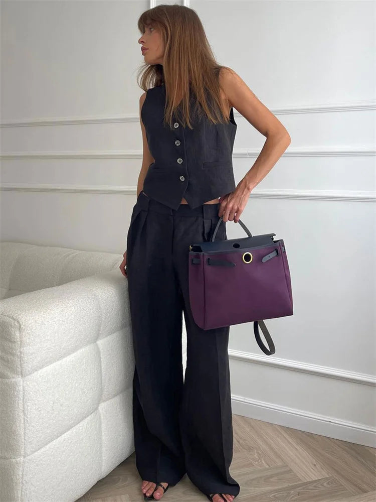 Women's white high-waist linen wide-leg trousers with relaxed fit and tailored design, perfect for casual or chic outfits.