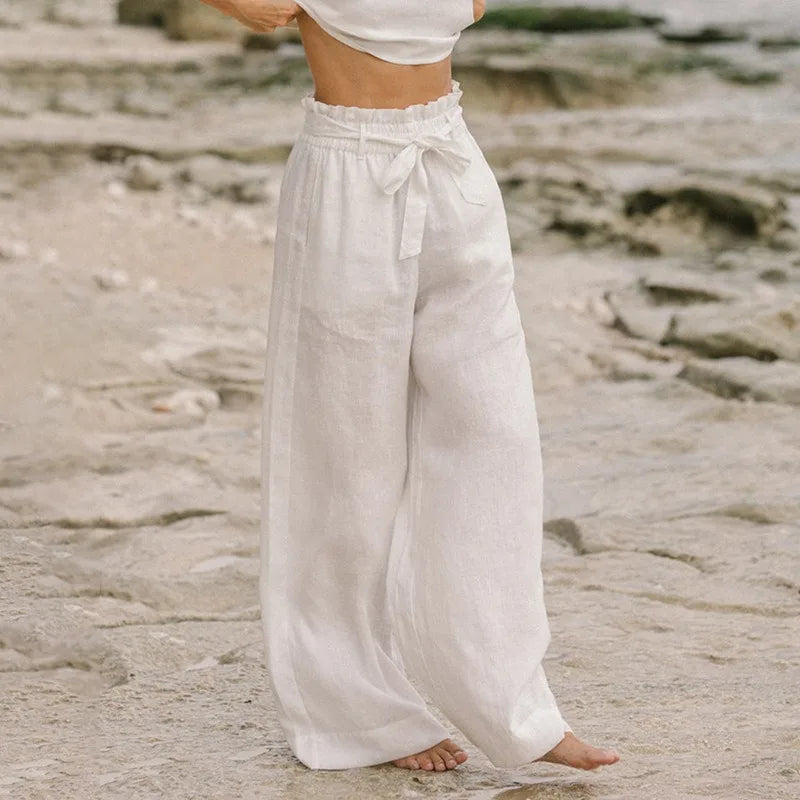 Light beige linen wide-leg trousers for women with loose pull-on style, relaxed fit, and comfortable waistband.