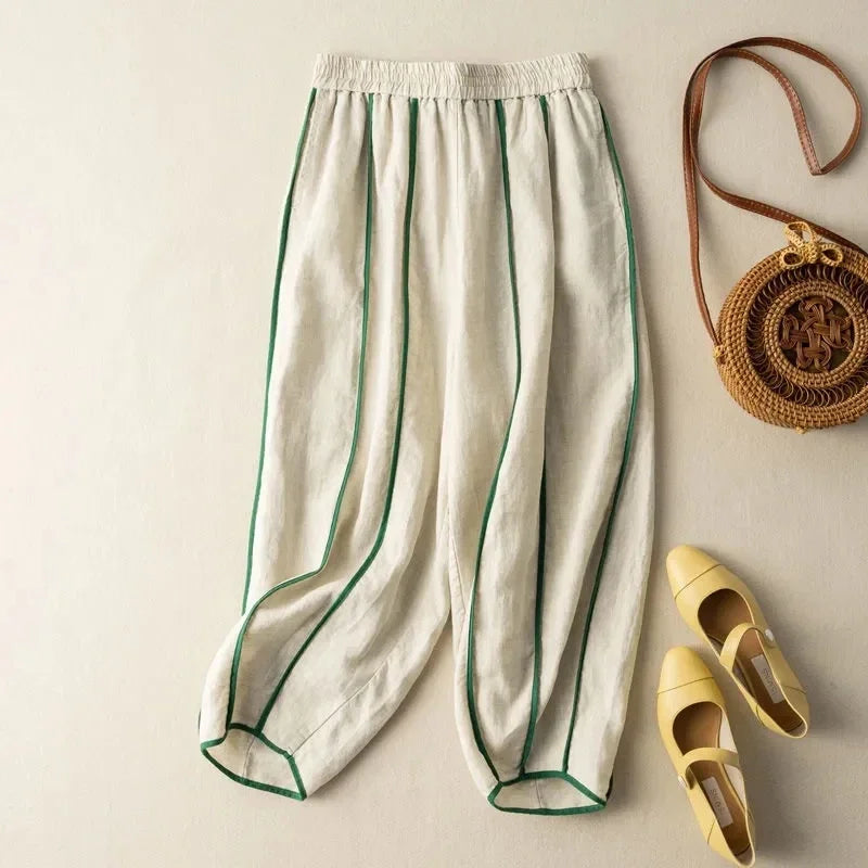Light blue and white striped wide-leg linen trousers for women, with a loose pull-on style and relaxed fit.