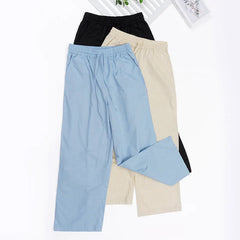 Light beige cotton linen wide-leg women’s drawstring trousers with a loose fit and pull-on design, perfect for casual comfort.