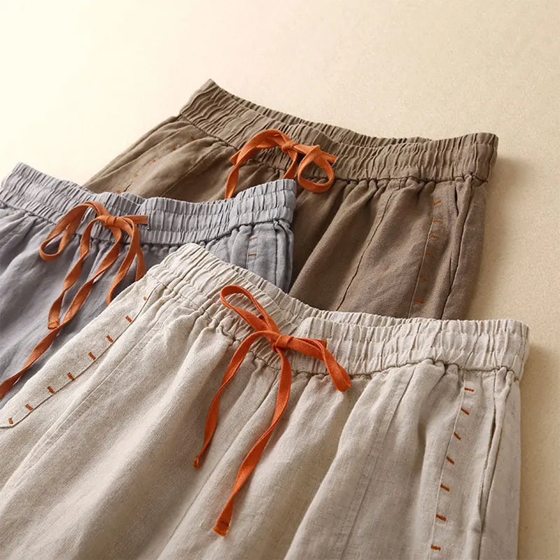 Women's linen wide-leg drawstring trousers with a loose fit, featuring a comfortable pull-on design and relaxed style.