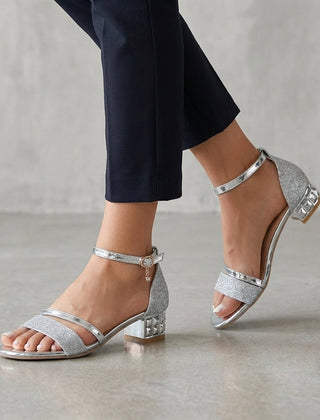 Silver metallic block-heel ankle-strap sandals for women by Tammy Bradley, showcasing stylish straps and heel detail.