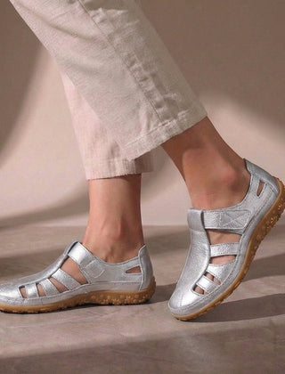 Silver cutout fisherman sandals for women by Tammy Bradley, featuring open toe design and adjustable straps.