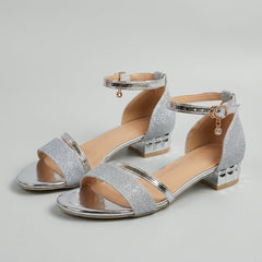 Tammy Bradley metallic block-heel ankle-strap sandals for women, featuring a stylish design and open-toe style in a studio setting.