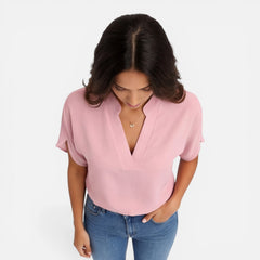 Lightweight women's chiffon blouse with V-neck, casual summer top in soft, flowing fabric suitable for warm weather.