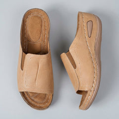 Open-toe orthopedic wedge slide sandals for women with side details, featuring supportive design and casual style.