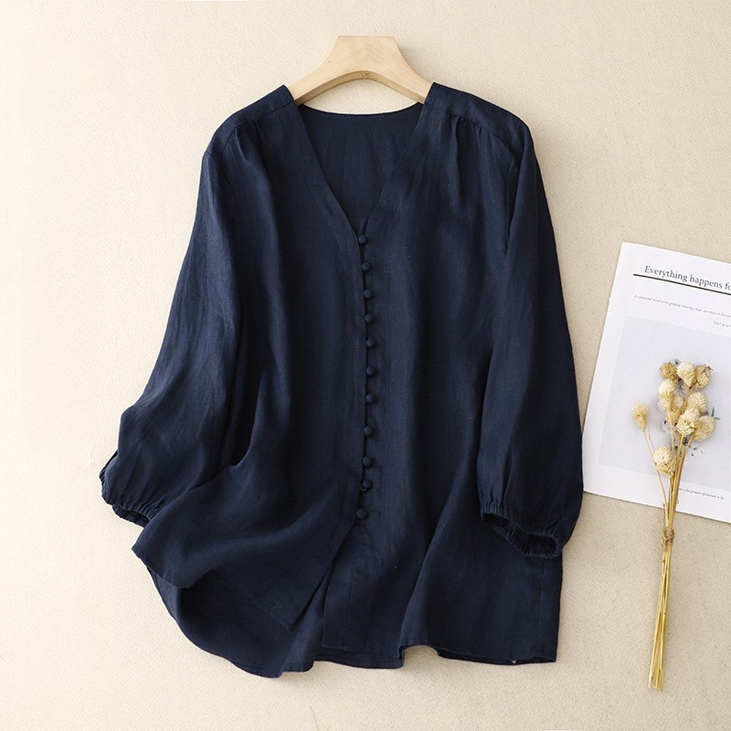 V-neck linen summer blouse for women featuring lightweight fabric and relaxed fit, ideal for warm weather.