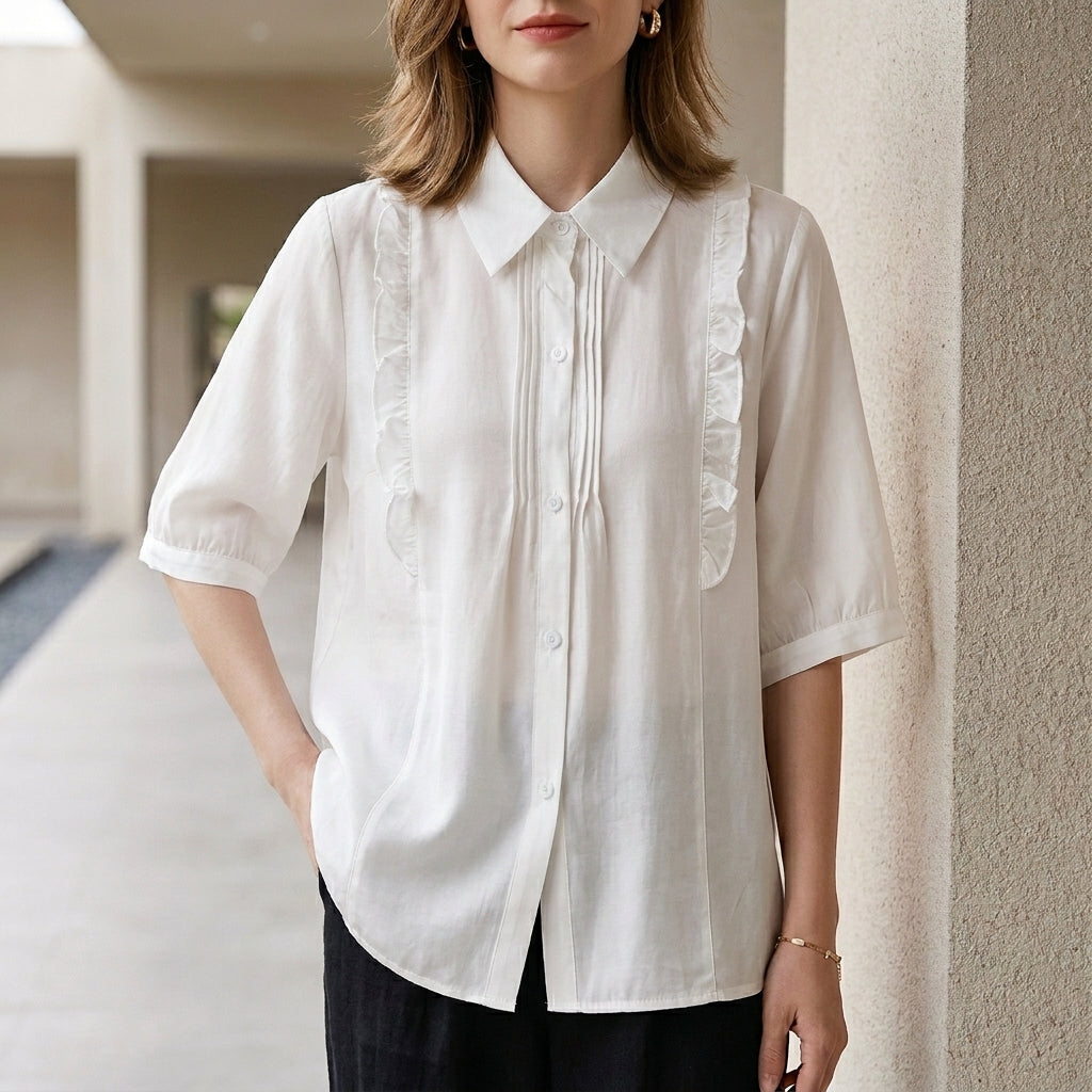 White denim ruffle summer blouse for women, stylish top with feminine ruffle details, perfect for warm weather.