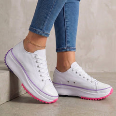 White orthopedic women's sneakers with lace-up design, providing comfortable support and stylish look.