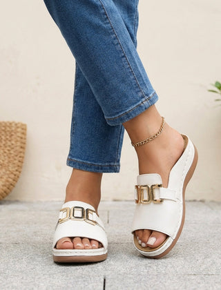 White orthopedic slide sandals with buckle detail and contrast stitching, featuring cushioned footbed and supportive sole for comfortable wear.