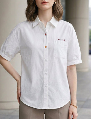 White women's summer blouse with puff sleeves, denim fabric, button front, casual style, perfect for warm weather.