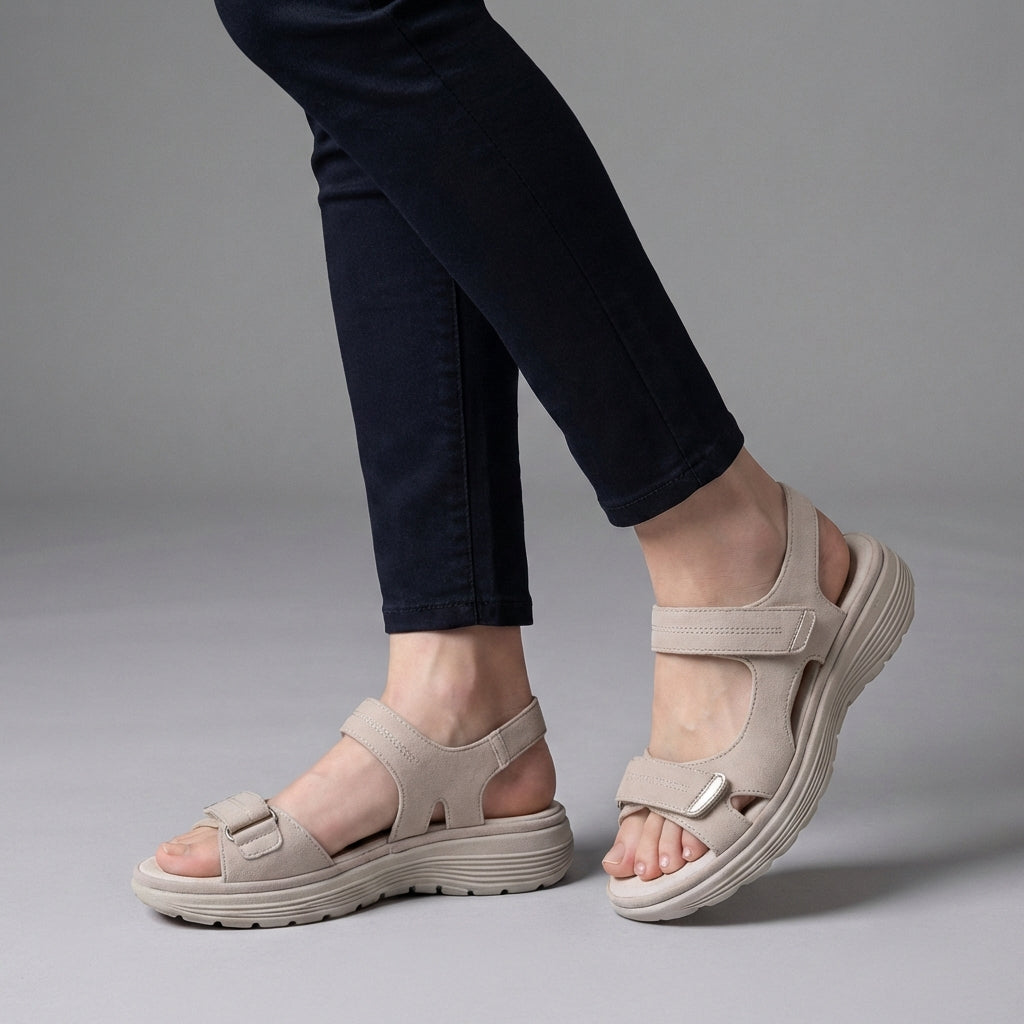 White orthopedic comfort fit sandals with chunky sole and adjustable straps, designed for support and casual wear.