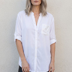 White women's summer blouse with V-neck and denim button front, casual top perfect for warm weather.