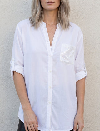 White women's summer blouse with V-neck and denim button front, casual top perfect for warm weather.