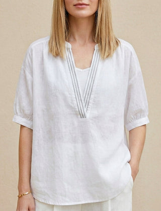 White women's summer blouse with V-neck and puff sleeves, stylish and lightweight top for warm weather.