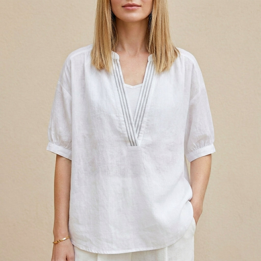 White women's summer blouse with V-neck and puff sleeves, stylish and lightweight top for warm weather.