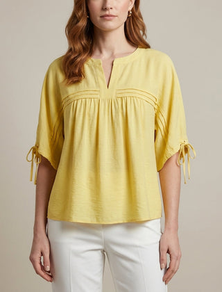 Yellow linen flowy summer blouse for women, stylish lightweight top perfect for warm weather and casual wear.